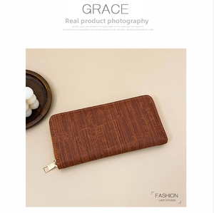 Detailed macro view of brown wooden texture long purse with a gold metal zipper closure