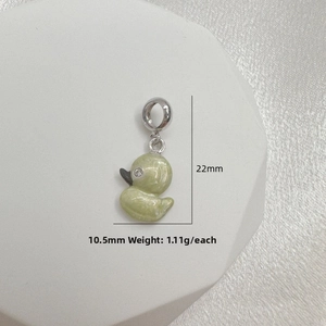 Detailed macro view of small duck charm with 22mm height and green pearl glaze