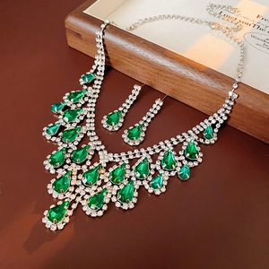 Detailed set of silver water-drop necklace and earrings with green emerald gemstones