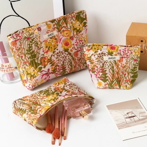 Three-piece floral embossed cosmetic bag set with large capacity and zipper closure