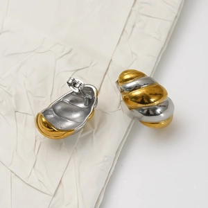 Modern two-tone twisted croissant stud earrings in 18K gold and silver finish