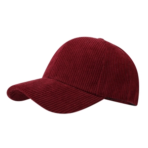 Detailed view of the dark red corduroy fabric texture on a warm baseball cap