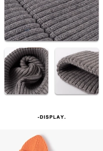 Close-up of thick rib-knit texture and folded cuff detail on dark grey winter beanie
