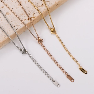 Detailed view of silver, rose gold, and gold stainless steel necklaces with lobster clasps