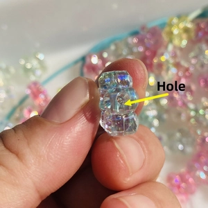 Macro shot of an iridescent aurora star DIY bead with hole for phone case accessories