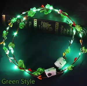 Detail of LED floral headband with green leaves, berries, and battery control box