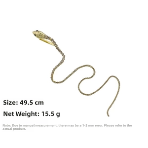 Macro detail of 49.5cm gold snake hair clip with shimmering rhinestones and black eyes