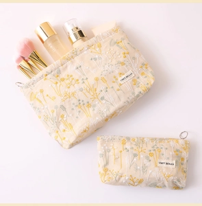 Detail of two-piece floral embroidery canvas makeup bag set with zip closure and brushes