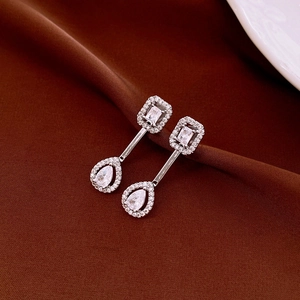 Detail of silver drop earrings with rectangular and pear-cut cubic zirconia crystals