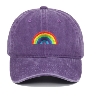 Macro detail of rainbow embroidery on purple washed cotton baseball cap with vintage texture