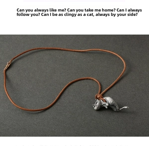 Macro view of detailed vintage 925 silver cat pendant with textured fur and brown leather cord