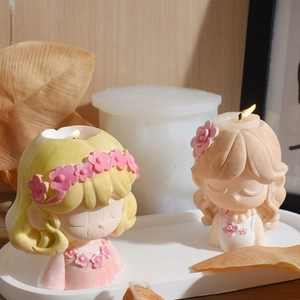 Detail of flower girl candle holder molds with finished resin statues on a tray