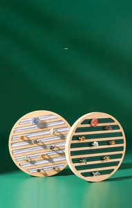 Detailed macro view of bamboo jewelry tray with grey and green velvet ring slots