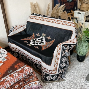 Bohemian style camping blanket with ethnic geometric patterns and fringed edges