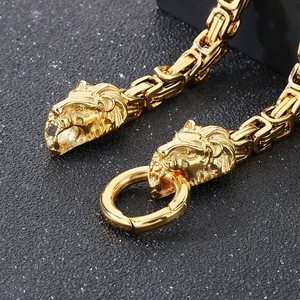 Macro shot of golden lion head clasp and intricate byzantine chain link detail