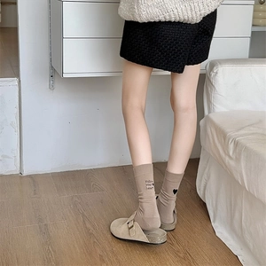 Detail of khaki crew socks featuring Follow Your Heart embroidery on soft cotton fabric