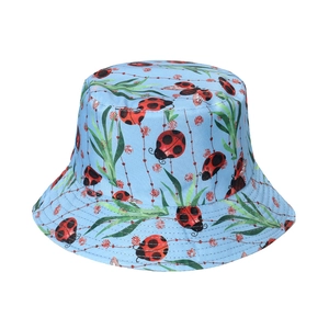 Light blue reversible bucket hat with red ladybug print and green leaf pattern