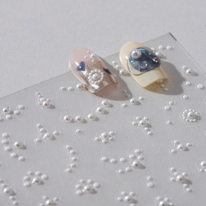 3D relief pearl nail stickers with floral patterns on self-adhesive backing sheets