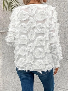 Detailed back view of white long sleeve blouse featuring textured fringe and feather accents