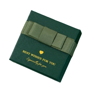 Green square jewelry gift box featuring a ribbon bow and elegant gold foil text