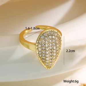 Detail shot of 18K gold plated teardrop ring with pave cubic zirconia on silk backdrop