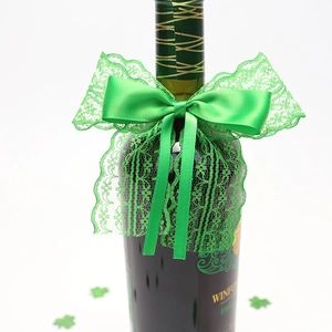 Detail of green lace ribbon bow and shamrock decor on a St. Patrick's Day wine bottle