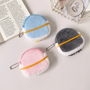 Detailed view of plush penguin mini pouches in blue, gray and pink with bead chains