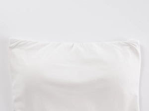 Detail view of the white elastic fabric and stitching on a seamless tube top for women