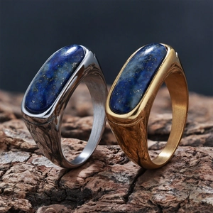 Detailed macro of gold and silver lapis lazuli signet rings on natural bark