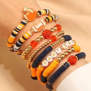 Macro shot of Game Day clay bead bracelets with football charms and gold accents