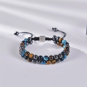 Macro detail of double-layer natural tiger eye stone beads and Tree of Life charm