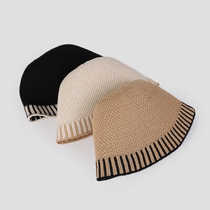 Detailed close-up of striped knit texture on minimalist bucket hats in multiple colors