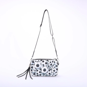 Crossbody camera bag featuring a classic soccer ball print and decorative tassel detail