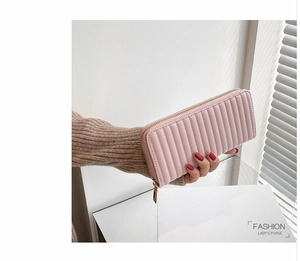 Pink PU leather long wallet for women featuring vertical quilted stitching and gold zipper