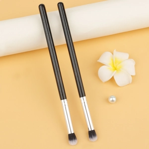 Dual-ended eyeshadow blender brush with black shimmer handle and two-tone fibers