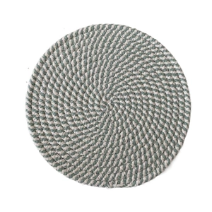 Close-up of woven round placemat in light green and beige cotton with spiral texture