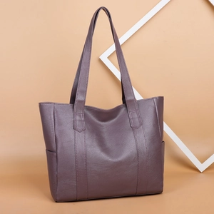 Large soft leather dark purple tote bag for women shown on a beige background