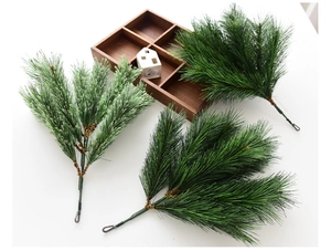 Detailed view of artificial PE pine needles with frosted and green textures for DIY wreaths