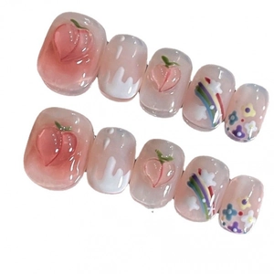 Handmade press-on nails with peach and rainbow designs in a sweet pink finish