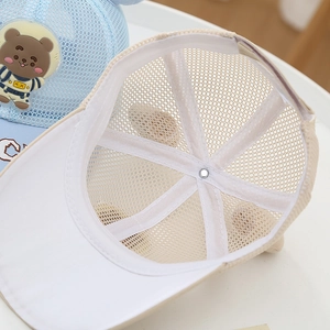 Detail view of breathable light blue mesh and cute astronaut bear patch on kid's cap