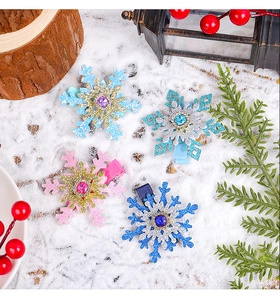 Close-up of snowflake hair clips with colorful rhinestones in a festive winter setting