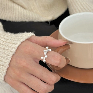 Minimalist 925 sterling silver beaded open ring shown in a cozy lifestyle setting