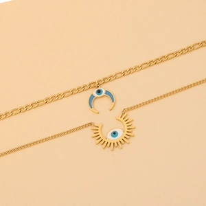 Detail of double-layer gold plated necklaces with blue evil eye moon and sun pendants