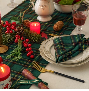 Detail shot of green festive plaid table runner and napkins for Christmas table decor