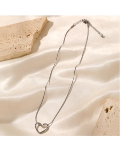 Detailed view of silver hollow heart pendant on high-density snake chain necklace