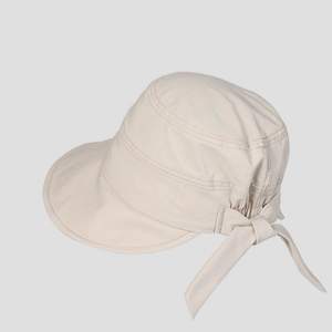 Detail view of beige sun hat with back bow tie and decorative stitching textures