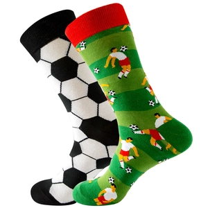 Soccer themed mid-calf socks featuring black and white ball patterns and green pitch design