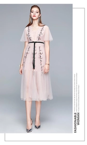 Détail de la robe rose clair en tulle avec col en V et broderie florale sophistiquée