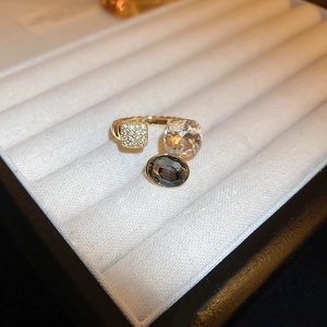 Macro detail of gold-plated dragon ring with cubic zirconia in a velvet box