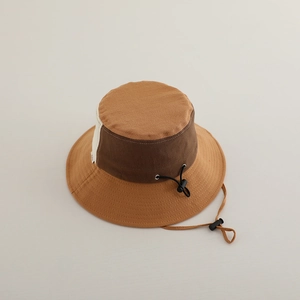 Close-up of kids color-block bucket hat showing adjustable drawstring and fabric texture